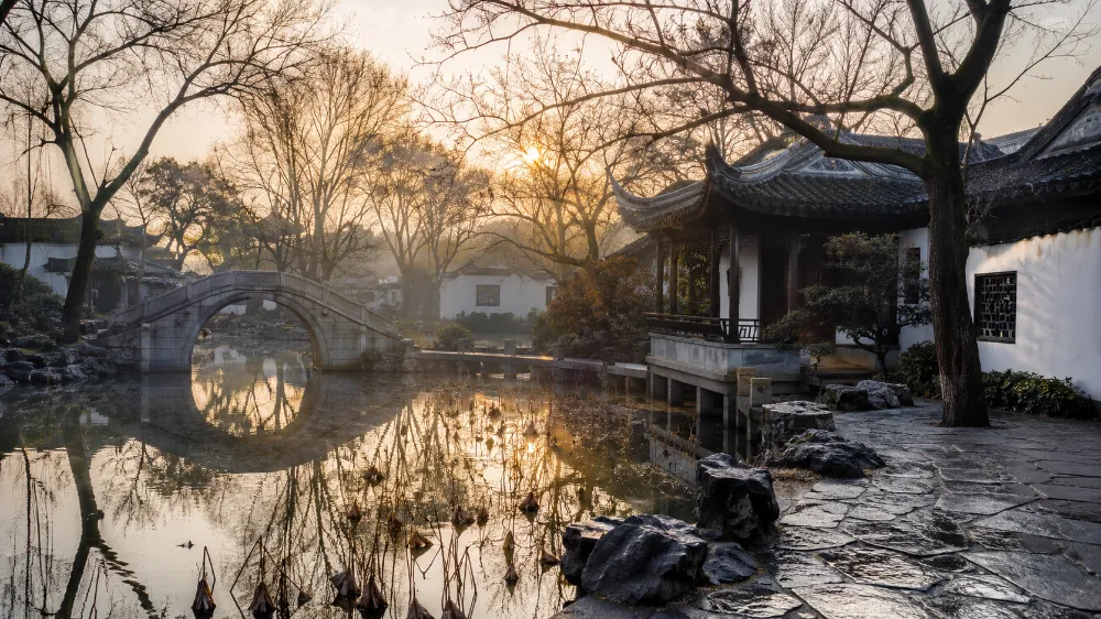 Humble Administrator's Garden in Suzhou in December with bare winter trees and soft morning light