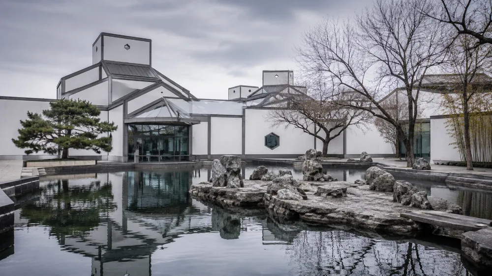 Suzhou Museum designed by I.M. Pei in winter with minimalist white architecture and reflecting pool
