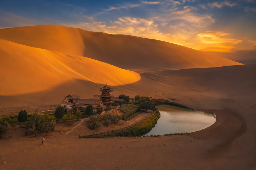Crescent Lake oasis nestled among the golden sand dunes of Mingsha Mountain in Dunhuang