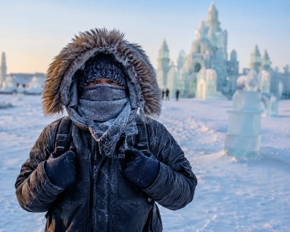 A visitor dressed in heavy winter layers to handle the extreme cold at the Harbin Ice Festival