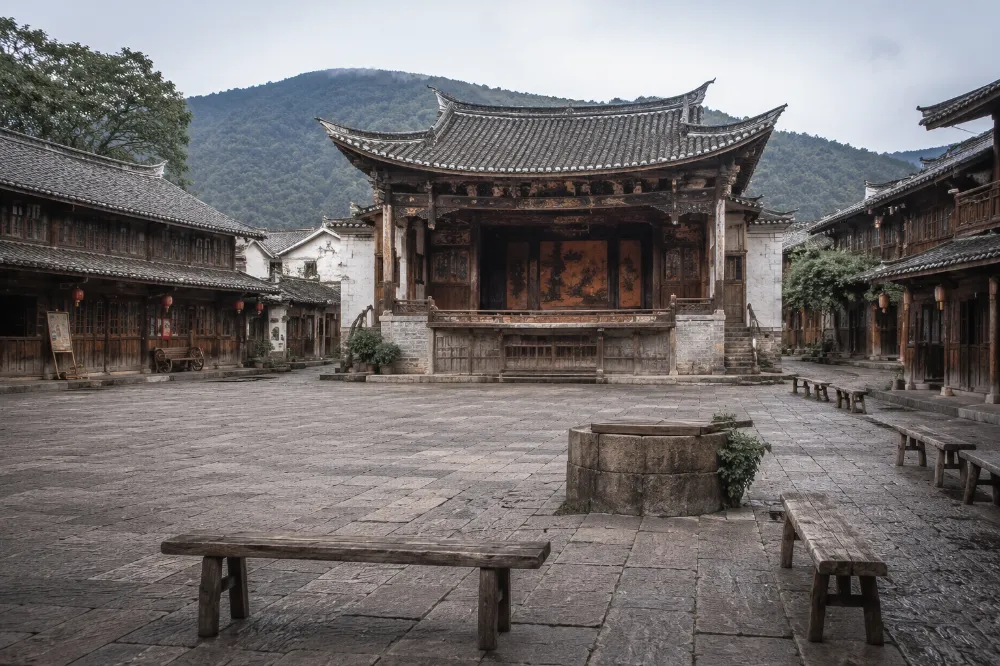 Shaxi Old Town in Yunnan, a stone-paved courtyard with a 600-year-old wooden theater in the background