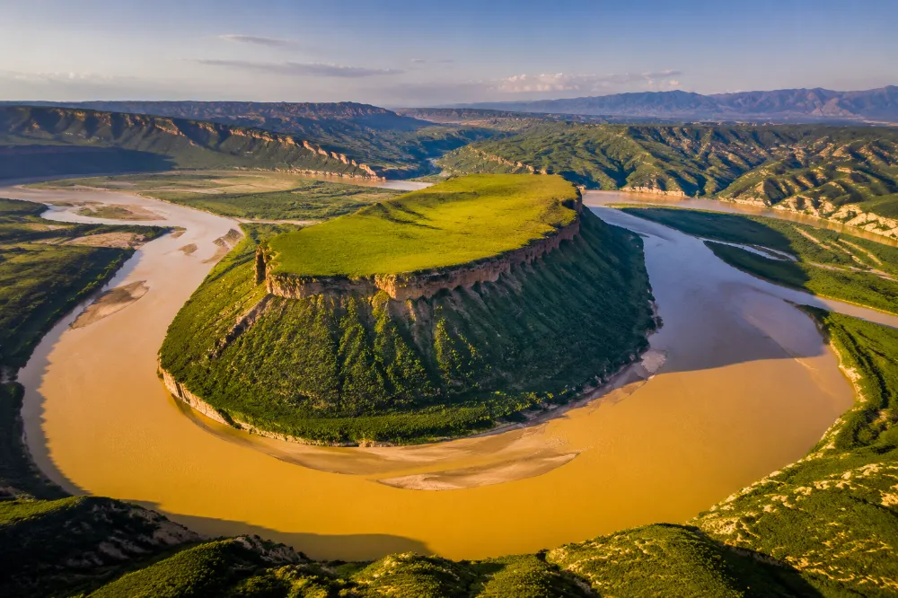 Aerial view of the Yellow River bending around a flat-topped mesa at Sanguan, Ningxia