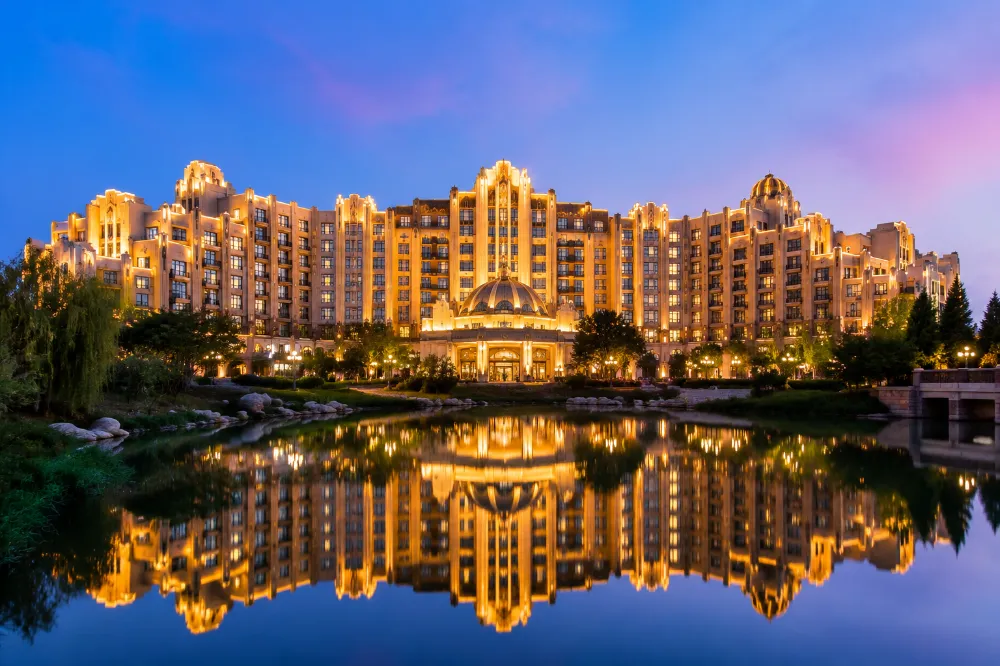 Shanghai Disneyland Hotel reflected in the lake at twilight, the flagship on-site resort hotel