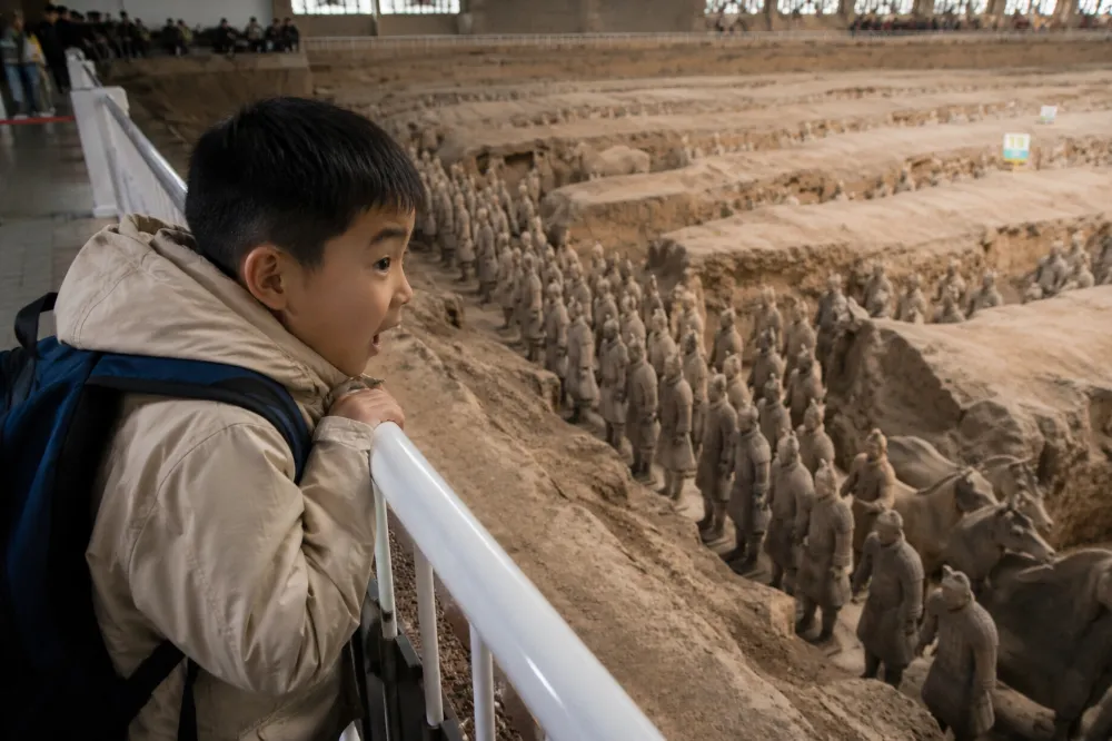 Kids marveling at the Terracotta Warriors during a family China tour in Xi'an