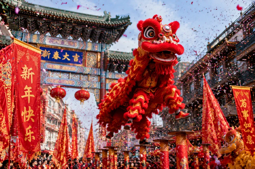 A traditional red and gold Chinese lion dance mid-jump during a Lunar New Year 2027 celebration