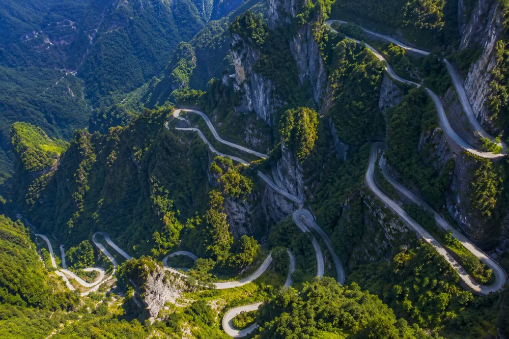 The 99 Bends Road winding up Tianmen Mountain cliff face, visible from the world's longest alpine cable car
