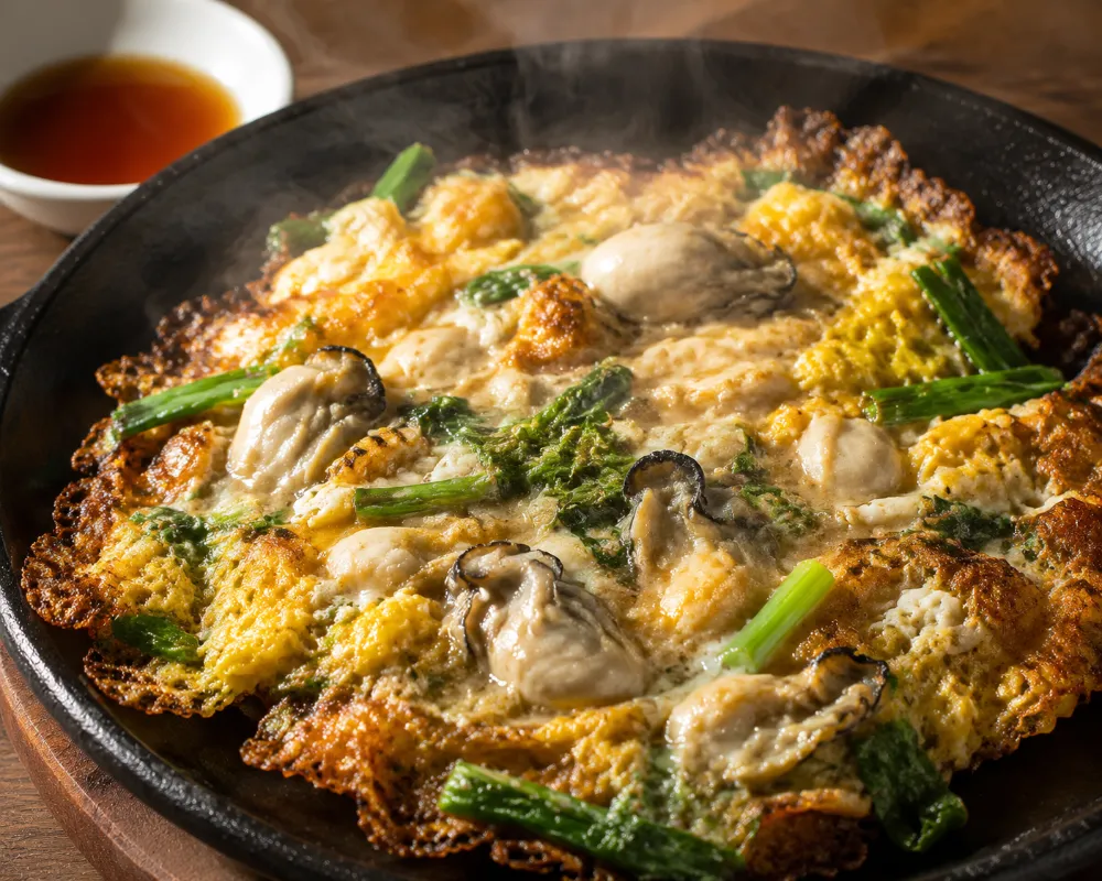 Freshly cooked Teochew oyster omelette with crispy edges and juicy oysters, a signature Chaozhou street food snack